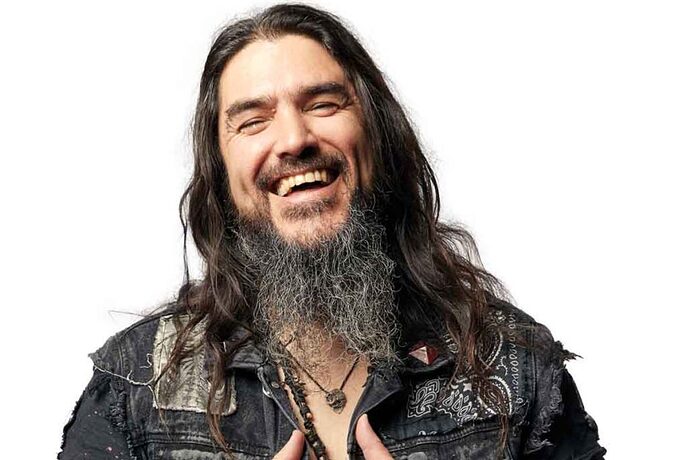 robb-flynn-smiling-and-standing-before-a-white-backplan-1024x683
